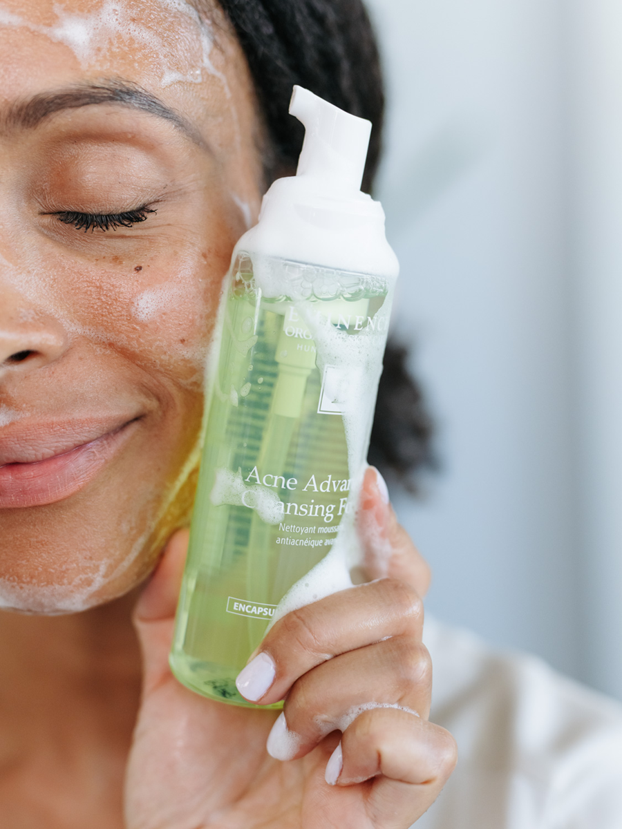 woman holding Eminence Organics Acne Advanced Cleansing Foam