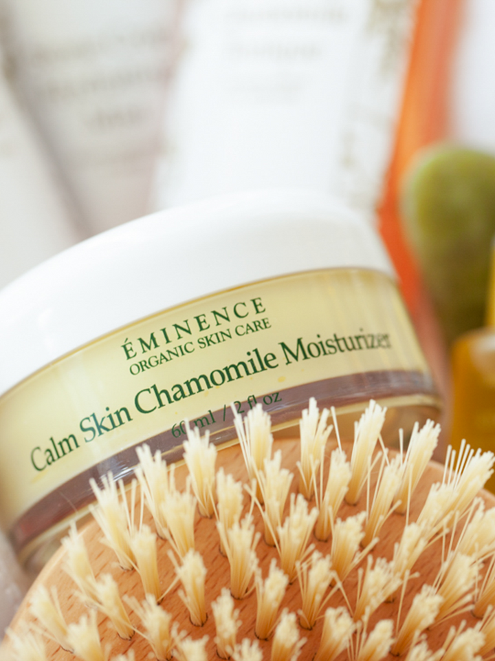 Eminence Calm Skin Chamomile Moisturizer with a brush in the foreground