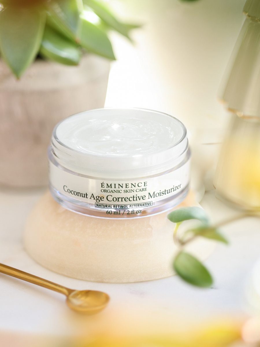 Eminence Coconut Age Corrective Moisturizer jar by with a blurred natural background