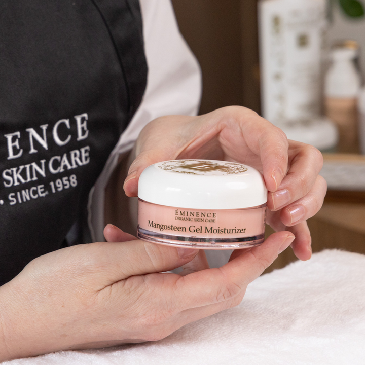 woman holding Eminence Organics Mangosteen Gel Moisturizer