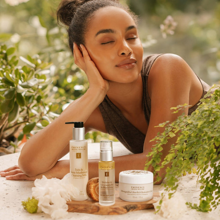 Eminence Organics Shiitake & Ashwagandha Bi-Phase Mist and Collection with model in background
