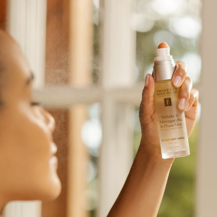 Eminence Organics Shiitake & Ashwagandha Bi-Phase Mist spraying on model face