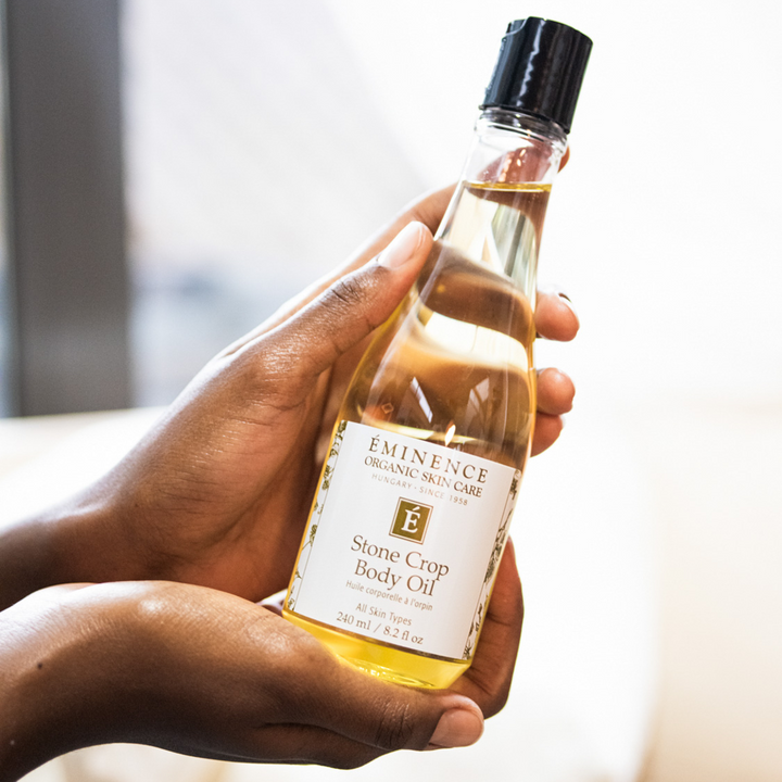 hand holding Eminence Organics Stone Crop Body Oil