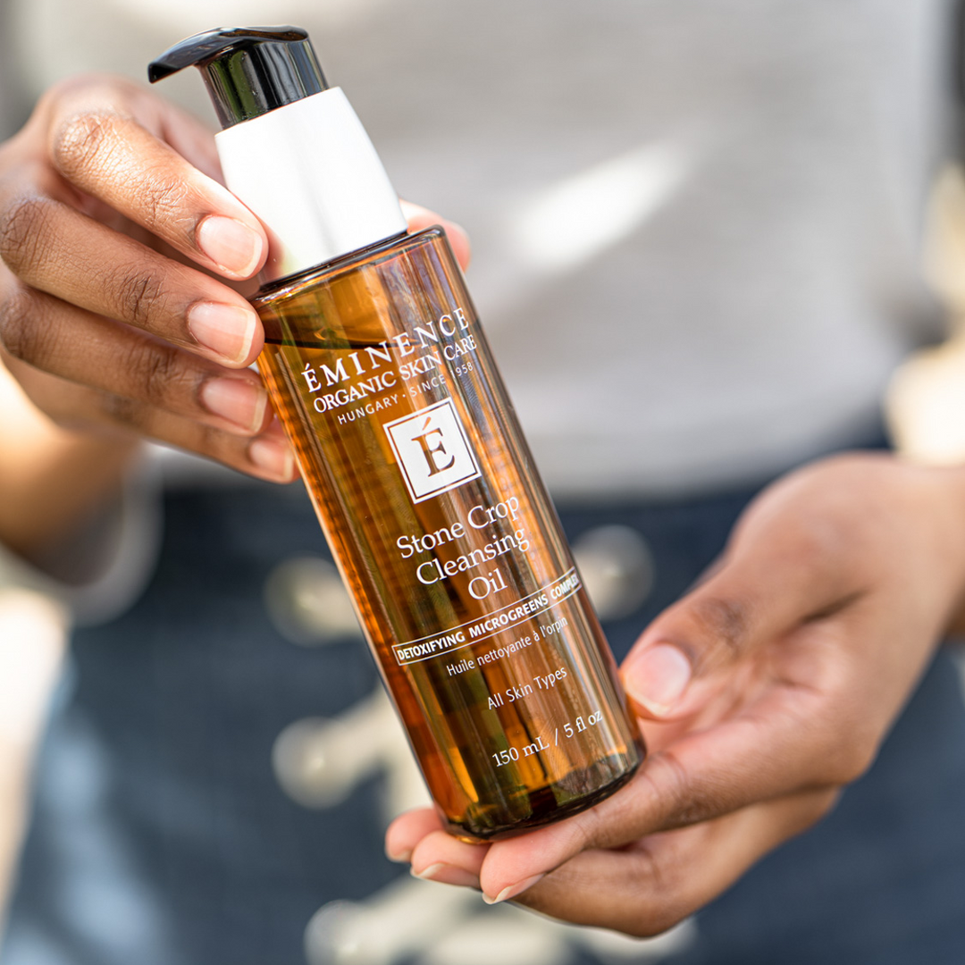 woman holding Eminence Organics Stone Crop Cleansing Oil