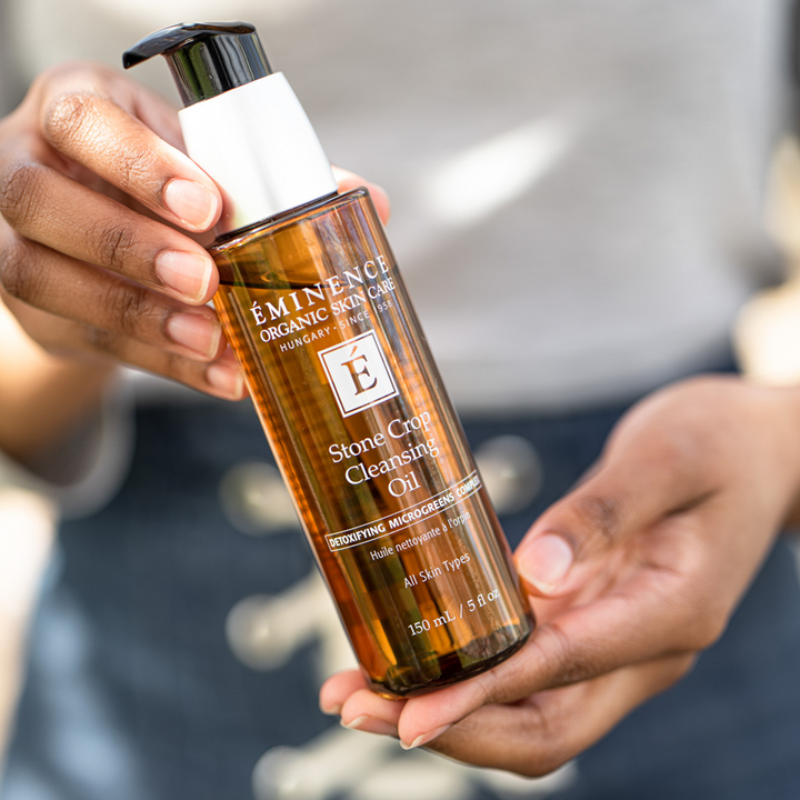 woman holding Eminence Organics Stone Crop Cleansing Oil